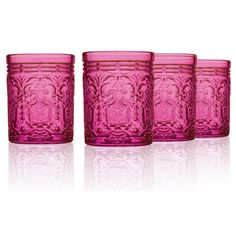 four pink glass tumblers sitting next to each other