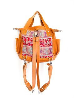 Convertible full grain leather bag with removable straps to wear in three different ways. Includes leather cross body strap and a pair of backpack straps. This mini backpack is made using a traditional huipil from the village of Chichicastenango, Quiché. - 100% foot loomed cotton lining - Artisan made woven huipil- One interior zipper pocket, zipper closure- Hand sanitizer included as in picture- Inside Pockets- Two exterior open pockets - Full camel grain leather - Zipper closure * This bag is Artisan Satchel With Adjustable Strap, Artisan Satchel With Adjustable Strap Crossbody, Bohemian Shoulder Bag With Detachable Strap For Travel, Artisan Crossbody Satchel With Adjustable Strap, Leather Satchel Backpack With Handles, Leather Tote Shoulder Bag With Adjustable Straps, Leather Shoulder Bag Tote With Adjustable Straps, Traditional Leather Satchel With Adjustable Strap, Camel Crossbody Satchel For Travel