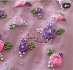 the cake is decorated with flowers and pearls