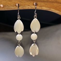 Genuine, Carved Mother Of Pearl Pikake Flowers Dangle Earrings, Carved And Polished Sea Coral Bead Accents, And Sterling Silver Earring Hooks. Handmade: Beautiful, Unique, Lightweight, And Elegant! White Sterling Silver Pierced Flower Earrings, White Drop Pierced Earrings, White Sterling Silver Chandelier Earrings Nickel Free, White Teardrop Flower Earrings Nickel Free, White Teardrop Hypoallergenic Flower Earrings, Delicate White Long Drop Earrings, Handmade Elegant Pearl Earrings In Flower Shape, White Sterling Silver Dangle Flower Earrings, Delicate White Teardrop Chandelier Earrings