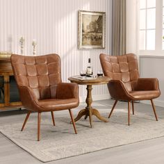 two brown chairs sitting next to a table on top of a white carpeted floor