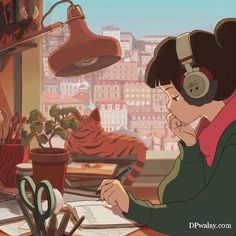 a woman sitting at a desk with headphones on and writing in a book while looking out the window