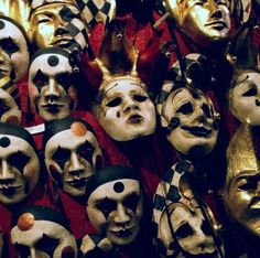 many masks are lined up on the wall