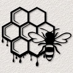 a black and white drawing of a bee next to honeycombs with dripping drops