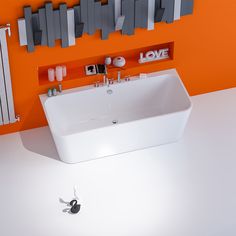 a bathroom with an orange wall, white sink and black faucet in it