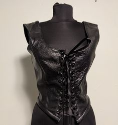 "These are made from real cow hide and not a synthetic leather. This is a group of random leather female formed jerkins, corsets, and dragon slayer leather over dress from off our display floor. We are clearing out our sales floor and many of these were samples or pieces to help determine fit. Some are patterning experiments made to decide if they would be a good fit in our shop so fabrics and construction might vary from our usual custom made item's. They are already packaged and ready to ship. Leather Stays, Gothic Leather Corset For Party, Medieval Style Fitted Leather Corset, Fitted Leather Corset For Cosplay, Fitted Leather Medieval Corset, Luxury Fitted Leather Corset, Gothic Leather Corset For Cosplay, Medieval Leather Fitted Corset, Gothic Leather Overbust Corset