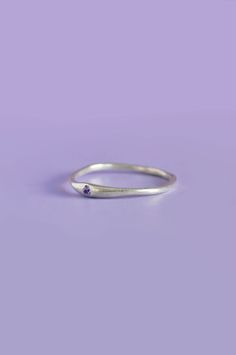 The Siyum gem ring is a true minimalist piece, a fine seamless round band is hand brushed finished allowing a contemporary aesthetic. Perfect for everyday, once you take it off you won't take it off! A petite round White Sapphire adds a beautiful detail and personalised touch. Use the drop down to select your ring size.If you are unsure of your ring size refer to our size guide. Please select your ring size carefully, and reach out if you have any questions. DetailsSterling Silver Handcrafted in Everyday Jewelry With Tension Setting In Round Band, Everyday Midi Rings With A Modern Twist, Modern Twist Midi Rings For Everyday, Minimalist Round Cut Everyday Birthstone Ring, Sterling Silver Rings With Tension Setting For Everyday, Minimalist Birthstone Ring With Bezel Setting, Minimalist Jewelry With Smooth Bezel As Gift, Minimalist Everyday Birthstone Ring With Round Band, Minimalist Round Band Midi Rings For Promise