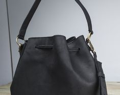 "I create my bags with high attention for details and I always respect high standards of quality. For this bag I used a soft Italian leather that gives a pleasant feeling at touch and I added all the features you would like to have on a bucket bag. The inside is fully lined and it has 3 pockets, one of them closed with a zipper for quick-access items, where you can keep your keys, your phone and other small thing that we normally lose in the abyss of our bags. To have a more secured bag, it clos Daily Use Bucket Bag With Handle Drop, Daily Use Shoulder Bag With Bucket Shape, Travel Bucket Bag With Handle Drop, Daily Use Shoulder Bag With Handle Drop, Black Shoulder Bucket Bag Gift, Black Bucket Hobo Bag With Handle Drop, Black Bucket-shaped Bags For On-the-go, Black Bucket Bags For On-the-go, Black Leather Handle Bucket Bag