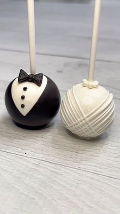 two cake pops decorated with black and white fondant, one in a tuxedo