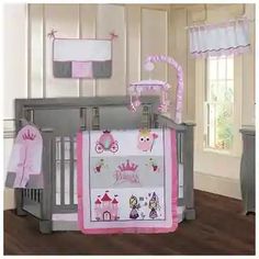 a baby crib bedding set with pink and gray accents