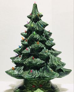 a ceramic christmas tree sitting on top of a table