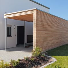 a house with a wooden roof and white walls