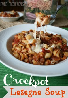 a plate with pasta and sauce being drizzled over it's top