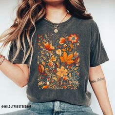 This super cute botanical shirt makes the perfect addition to your fall wardrobe. You will love it! Also makes a great gift! Please note: If you would like an oversized t shirt dress look then please consider ordering at least two sizes up from your normal size. Feel free to reach out if you have any questions. How we make our shirts - The design shown is printed directly onto the shirt using a professional grade DTG printing machine that allows the ink to absorb into the fabric. This allows your shirt to last longer and will prevent cracking or peeling over time. You will love it! If you have any questions please feel free to reach out to us in an Etsy message and we will be happy to assist you.  HOW TO ORDER  1. Select the size and color of the shirt you would like to order. 2. Add the q Relaxed Fit Printed Shirt For Fall, Printed Shirt With Relaxed Fit For Fall, Fall Cotton T-shirt With Vintage Print, Casual Fall T-shirt With Vintage Print, Casual Vintage Print T-shirt For Fall, Fall Bohemian Printed Shirt, Short Sleeve Floral Print Tops For Fall, Bohemian Printed Fall Shirt, Bohemian Printed Shirt For Fall