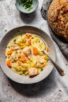 a bowl of chicken pot pie soup next to a loaf of bread