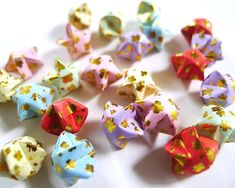 several different colored dices on a white surface