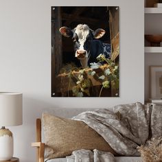 a black and white cow standing in front of a barn door with ivy growing around it