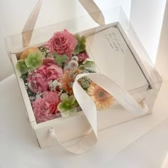 an open box with flowers inside on a table