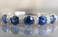 a blue and white ring with diamonds on it