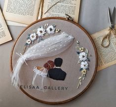 the embroidery is being worked on with scissors and thread to make it look like they are married