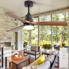 a living room filled with furniture and a ceiling fan in the middle of it's center