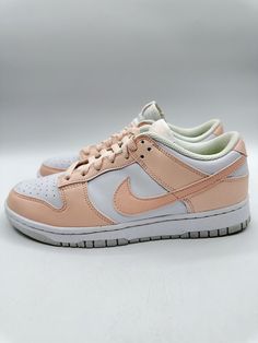 Elevate your sneaker game with these Nike Dunk Low Next Nature sneakers. The pale coral and white colorblock design is accented with beaded details and a lace-up closure for a comfortable fit. These sneakers are perfect for any occasion, whether you're hitting the gym, running errands, or skateboarding. The rubber outsole provides traction, and the cushioned insole ensures comfort. These shoes are available in US size 7.5 and UK size 6.5, with a standard shoe width. The low-top silhouette and breathable fabric make them ideal for year-round wear. Add these Nike Dunks to your collection today! Nike Dunk Low Next Nature, Sneaker Games, Nike Dunk Low, Dunk Low, Nike Dunk, Nike Dunks, Skateboarding, Running Errands, Low Top