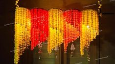 a chandelier made out of plastic beads hanging from the ceiling in a room