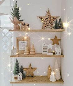 christmas decorations on wooden shelves in a white room with stars and lights around the edges