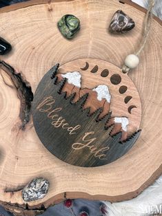 a wooden plaque with the words be brave like on it, surrounded by rocks and stones