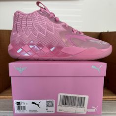 a pink shoe is sitting on top of a box