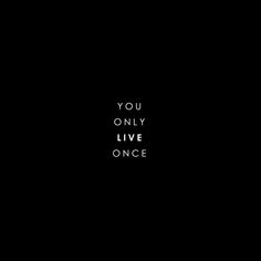 the words you only live once written in black on a dark background with white lettering