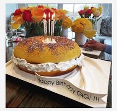 a birthday cake sitting on top of a table with candles in the middle of it