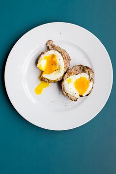 an egg is sitting on top of some kind of meat with cheese and mustard in it