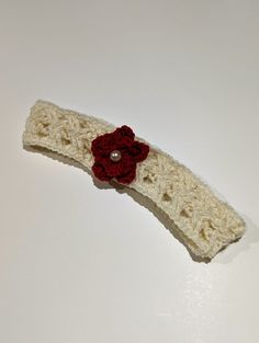 This hand knit baby headband was made with softness and comfort in mind. It is embellished with a small white pearl to add to the intricacy of the knitting pattern. Size: - Head size 17 inches (circumference) Fabric & Care: - 100% Merino Wool (Super-wash) - Use detergent for fine wash without softener Questions? - Feel free to reach out and we'll get back to you as soon as possible. Handmade Adjustable Cream Hair Accessories, Handmade Cream Headband, Handmade Cream Hair Headband, Handmade Yarn Headband As Gift, Handmade One Size Headband For Gift, Handmade White Headband, Handmade Headband Gift, Knit Baby Headband, Baby Red