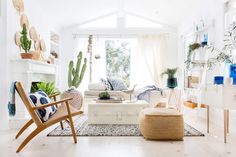 a living room filled with furniture and lots of plants