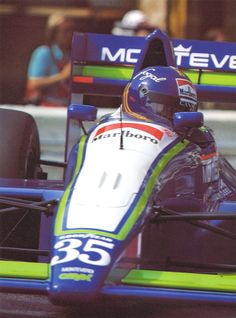 a man driving a racing car on top of a track