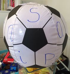 a large soccer ball sitting on top of a table