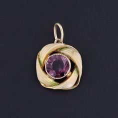 This charm features a purple glass doublet set in 10k gold, adorned with pale green enamel.  The charm was originally an antique stick pin (circa 1900) that our jeweler transformed by removing the pin stem and adding a jump ring bail.  The charm measures 0.75 inches from the top of the jump ring to bottom by 0.5 inches wide, and it is in great condition. We have many other fantastic offerings of antique and vintage jewelry posted on our Etsy store, so please consider browsing our other items. We Vintage Enamel Jewelry With Gemstone, Vintage Enamel Gemstone Jewelry, Art Nouveau Yellow Gold Pendant Jewelry, Art Nouveau Yellow Gold Jewelry Gift, Collectible Art Nouveau Yellow Gold Jewelry, Antique Round Jewelry With Bail, Vintage Purple Round Pendant Jewelry, Elegant Enamel Jewelry With Vintage Charm, Antique Purple 14k Stamped Jewelry