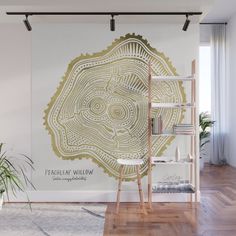 a white and gold wall mural in a living room with wooden flooring, potted plant