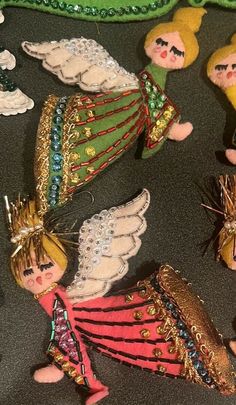 several small angel ornaments are on the floor next to each other, including one with wings and two with halos