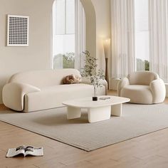 a living room with white furniture and windows