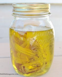 a jar filled with yellow liquid sitting on top of a table