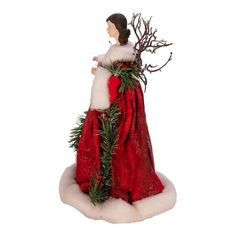 a christmas ornament with a woman dressed in a red dress and white fur