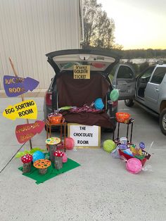 the trunk of a car is open with decorations and signs in front of it,