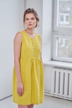 "MsWrinkle's clothing - from human to human. 100% handmade. *Description* - Sleeveless smock/maternity dress with pockets. Breastfeeding friendly ; - High quality European linen; - Washed and softened (doesn't shrink anymore); - Medium weight linen (150 g/m2); - Our linen is OEKO-TEX certified that meets human ecological safety requirements; - Model is wearing size S in lemon yellow, snow white, sky blue and elephant grey color (other sizes and colors please choose on the right) - Light colors l A-line Linen Dress With Buttons, Knee-length Linen Dress With Buttons, Linen Maternity Dress, Linen Maternity, Long Linen Shirt, Linen Slip Dress, Sleeveless Linen Dress, Linen Shirts Women, Loose Fit Blouse