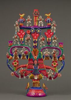 an elaborately decorated vase with birds and flowers on it's sides, in the shape of a chandelier