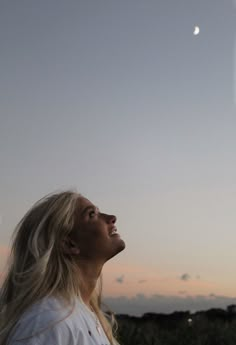 a woman is looking up at the sky