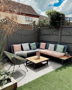 a couch and table in a small backyard