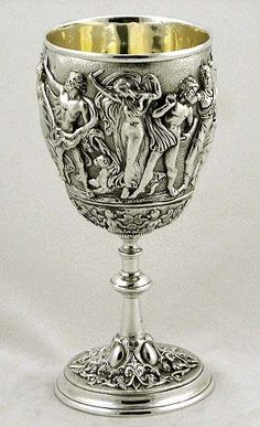 an ornate silver goblet with cherubs on it