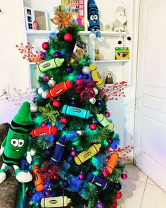 a christmas tree decorated with crayons and candy